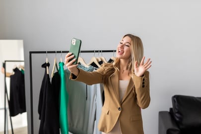 beautiful-young-woman-taking-selfie-shop-with-fashionable-clothes