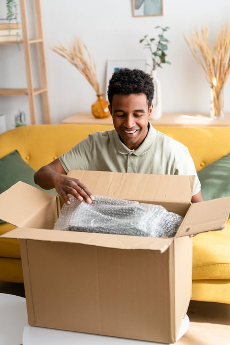 cheerful-black-man-unboxing-some-stuff-2023-11-27-05-14-18-utc