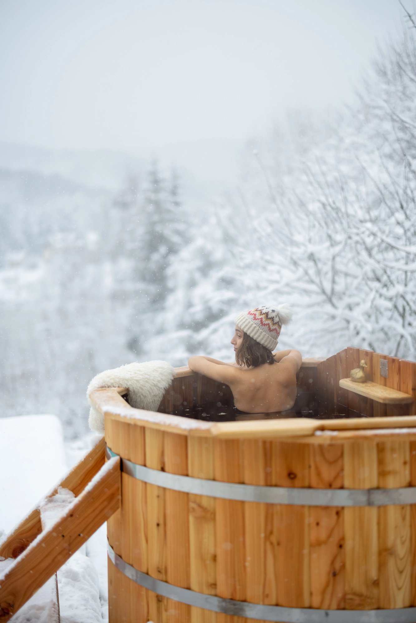 woman-relaxing-in-hot-bath-at-snowy-mountains-2023-11-27-04-52-06-utc